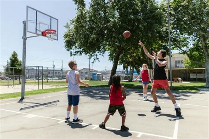 B.Lou is playing Basketball