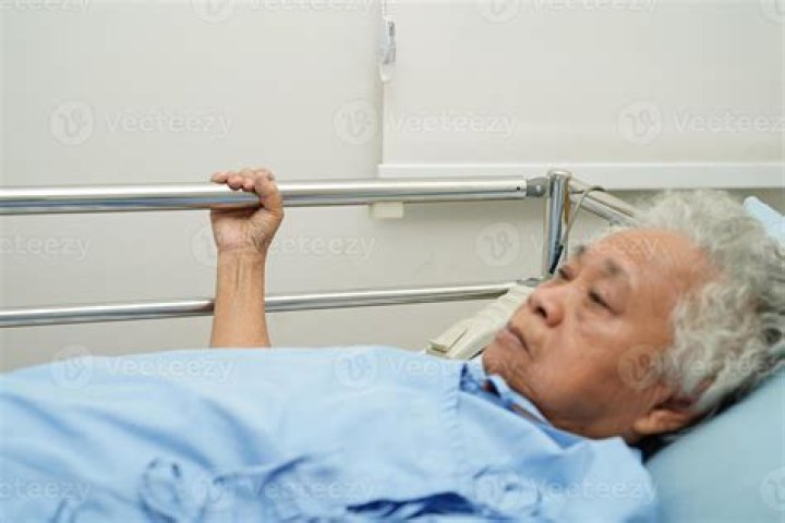 Patient Holding Pillow In Bed